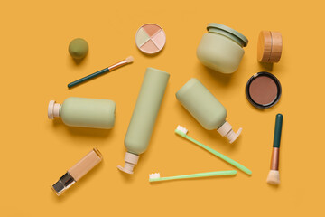 Composition with different cosmetic products and toothbrushes on color background