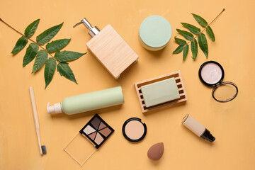 Composition with different cosmetic products and plant leaves on color background