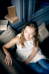 A young woman in jeans and a white shirt lets go of the day, allowing herself to simply be in the moment