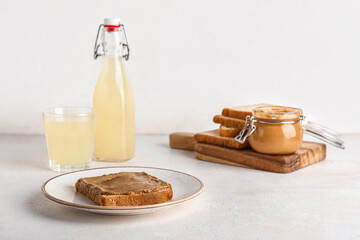 Plate of toast with peanut butter on white background