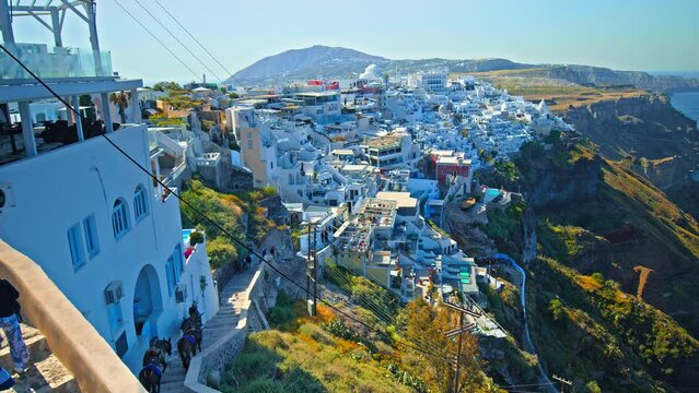 Donkeys carry the tourists up and down the endless steep In Santorini. Greek island with mules that Built Greece's Paradise in Santorini, Cyclades islands in the Aegean Sea.