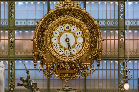 D&rsquo;Orsay Museum, Paris, France. 10.19.2015: Golden wooden clock from the 19th century. Interior of the Mus&eacute;e d'Orsay.