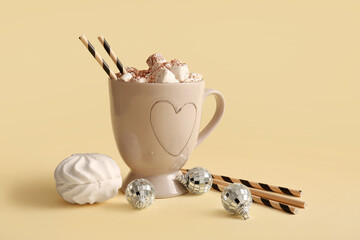 Cup of hot cocoa with marshmallows and Christmas balls on yellow background