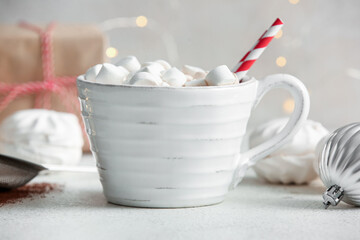 Cup of hot cocoa with marshmallows on white background