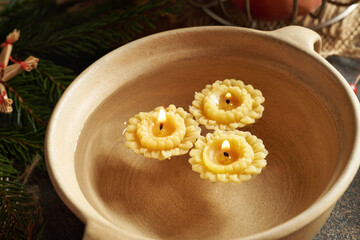 Candles made from bees wax floating in water - old Christmas custom