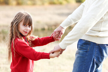Fototapeta premium father holding child's hand concept family support