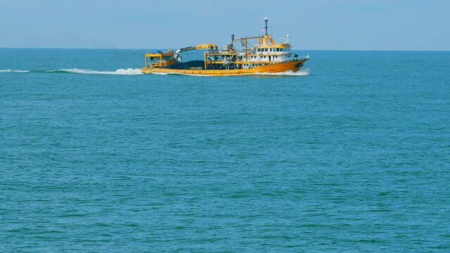 Seafood Production In The Sea Or Ocean. Fishing Boat Sails In The Open Sea. Real time.