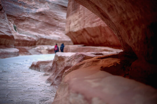 Kayon Sik. Bewin, dressed in traditional clothing, walks along the canyon wall. Petra Jordan