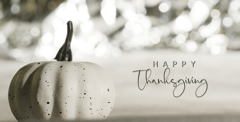 Elegant and fancy happy Thanksgiving background with shimmer behind white pumpkin, holiday greeting...