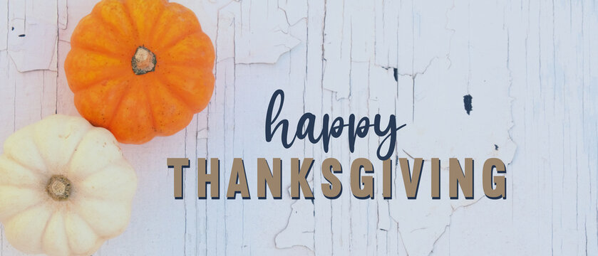 Happy Thanksgiving banner for holiday with pumpkins on white chippy paint background.