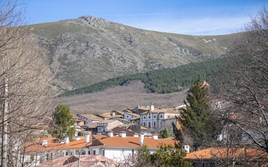 View of the village of Candelario with its houses, roofs and blue sky