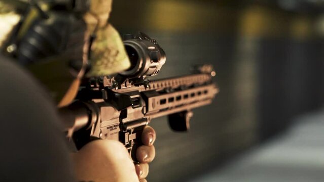 man in a camouflage uniform fires a machine gun at a shooting range at a shooting range