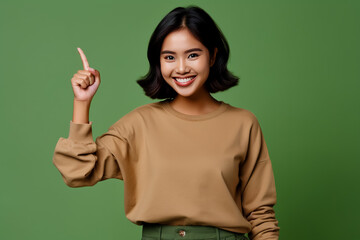Happy southeast Asian woman giving thumb up in studio on color background.