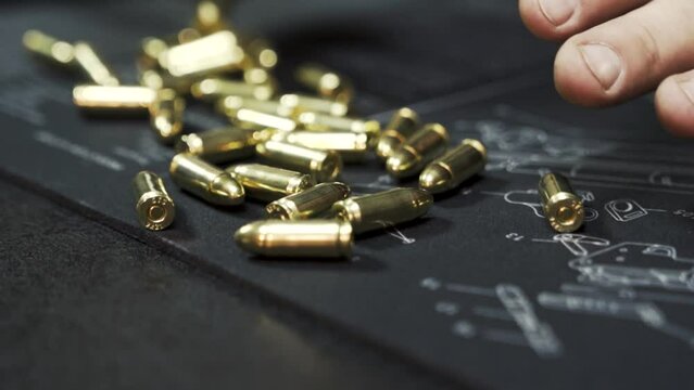 Machine gun ammo spills out onto the table in slow motion