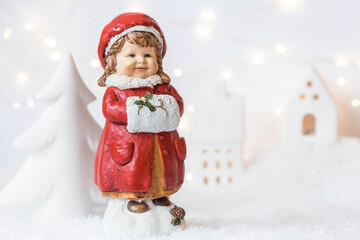 Retro Christmas card with a cute figure of a child on a snowy background. A girl in a red coat warms her hands in a muff. The concept of the winter holiday new year 2024.