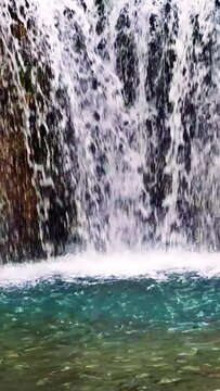 A small waterfall on a cascade of ponds.