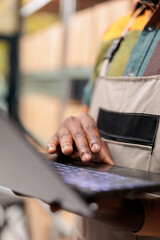 Storehouse manager looking at cargo stock on laptop computer before start preparing clients orders, checking shipping details, Employee working in delivery department, distribution center concept