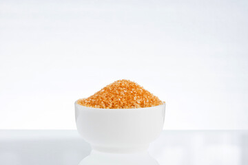 Cane sugar in white ceramic bowl - Saccharum officinarum