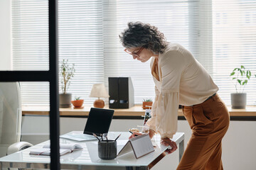 Side view of professional accountant or auditor looking through points of contract or financial...
