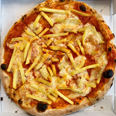 Pizza with french fries in delivery box. Tried but not very tasty.