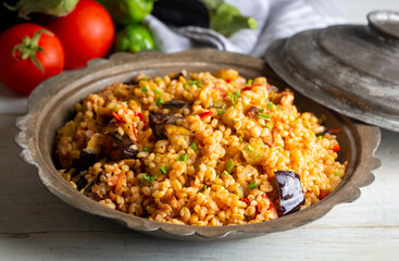 Traditional delicious Turkish food; Bulgur pilaf with eggplant and vegetables. (Turkish name; Patlicanli bulgur pilavi)