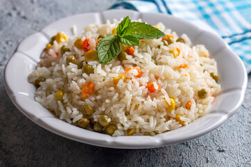 Delicious vegetable rice pilaf with green peas, carrots and sweet corn (Turkish name; sebzeli pilav)