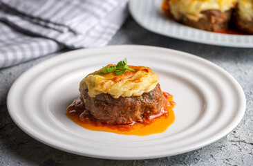Turkish Food Hasanpasa Kofte - Kofta with Puree - Meatball with Bechamel Sauce and Green Peas. Traditional Food.