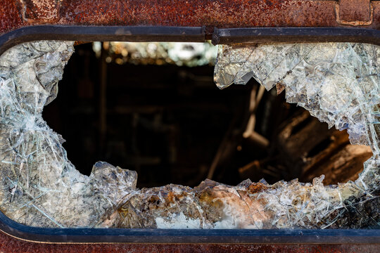 Bullet hole in armor-piercing glass. Armor piercing glass of damaged military infantry fighting vehicle during war between russia and Ukraine. Background, texture bulletproof glass after an attack