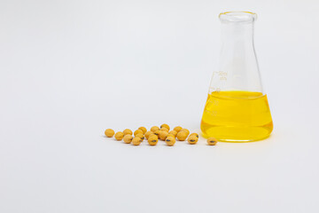 Soybeans with laboratory beaker. Genetically modified crops, soy oil, and biodiesel concept.