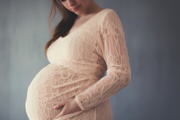 Image of pregnant woman touching her belly with hands - obrazy, fototapety, plakaty