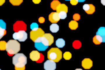 Blurry bokeh images with yellow, red and blue lights on a black background, 3d rendering