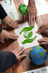Cohesive group of business people forming jigsaw puzzle pieces in environmental awareness symbol as...