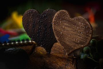 Wooden heart on wet wooden background