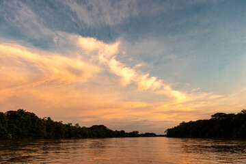Fototapeta na wymiar Sunset from the Guayabero River with beautiful colored sky. Meta, Colombia. 