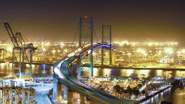 Aerial Time Lapse Shot Of Vehicles Moving On Bridge In Illuminated City Against Sky At Night - San Pedro, California
