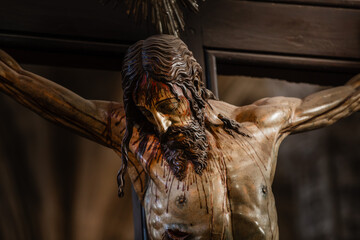 Painted wooden sculpture of Jesus Christ being crucified