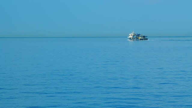 Fishing Boat Sailing .Ship Floats On Sea Surface With Blue Sky Leaving Path Sea Foam Water. Still.