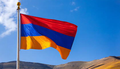 Close up view of an Armenia flag waving on a flagpole, with blue sky background and copy space