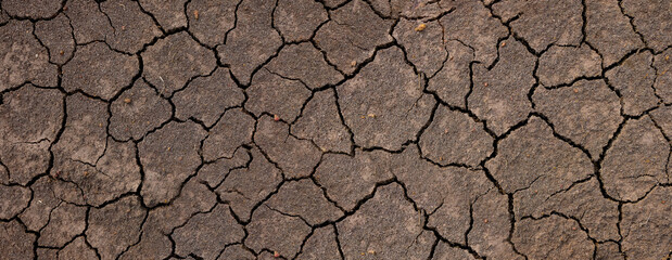 Wall texture soil dry crack pattern of drought lack of water of nature brown old broken background.