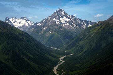Naklejka premium View of Mount Pshish - the highest peak near the village of Arkhyz and the valley of the Psysh River on a sunny summer day, North Caucasus, Karachay-Cherkessia, Russia