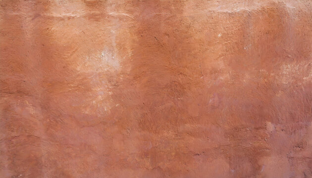 Abstract background of an exterior reddish brown adobe style textured wall surface