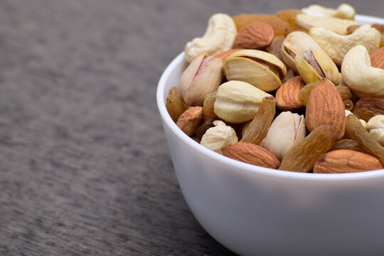 Closeup of mix nuts in bowl with text space