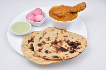Butter chicken and roti in plate on white background