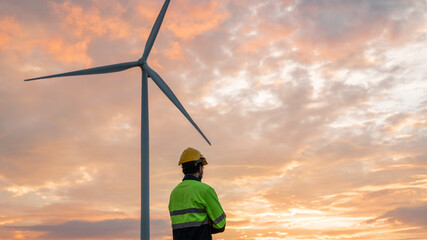 Service engineers checking system of windmill. Wind turbines generate electricity. Clean and...