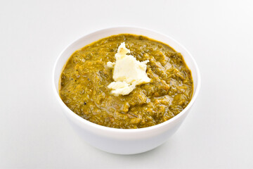 Saag with white butter in bowl on white background