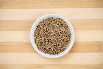 Caraway seeds top view on wooden board