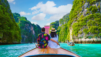 Couple in front of Longtail boat at the lagoon of Koh Phi Phi Thailand - obrazy, fototapety, plakaty