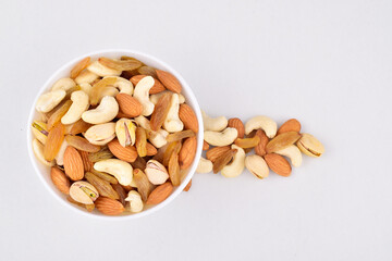 Top view of mix nuts in bowl on white background