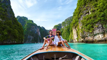 Poster Couple in front of Longtail boat at the lagoon of Koh Phi Phi Thailand © Fokke Baarssen