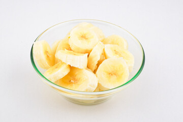 Banana slice in bowl on white background